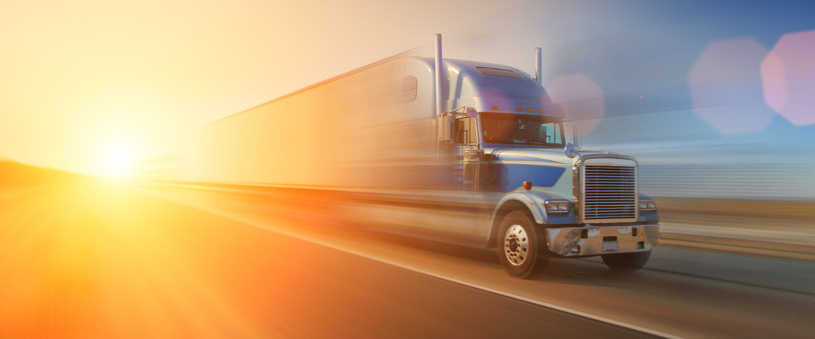Auto Liability Insurance - Semi Truck on highway at sunset.